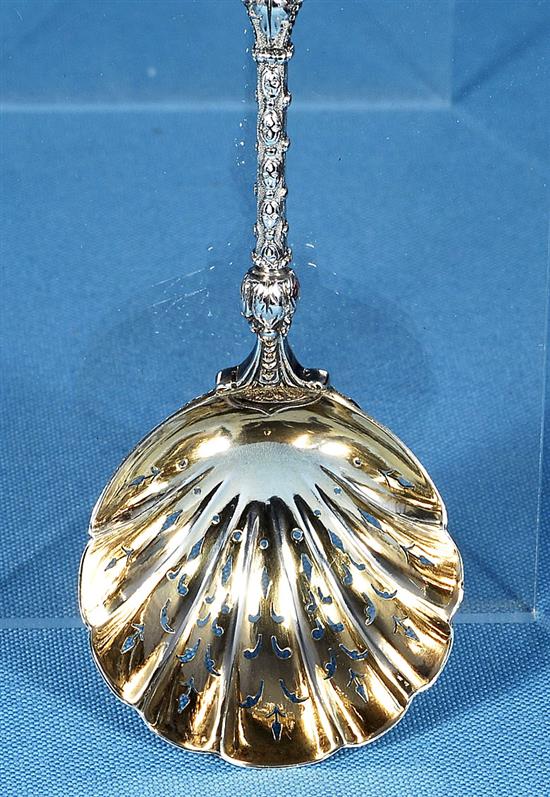 A cased set of four Victorian silver parcel gilt fruit serving spoons and a sugar sifter, spoon 197mm, weight 12.4oz/388 grms.